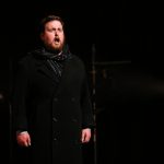 Colour photograph of Jonathan Forbes Kennedy, baritone, in a scene from Eugene Onegin by Tchaikovsky, RCS Opera Scenes (photo credit: Royal Conservatoire of Scotland)