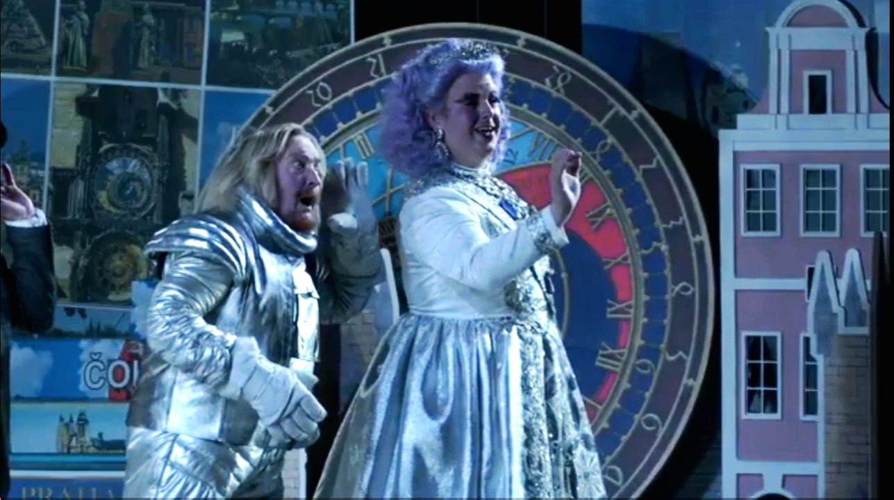 Colour photograph of Jonathan Forbes Kennedy, baritone, on stage as Postdatedcek with Andrew Shore as Paycek in The Excursions of Mr Brouček, Grange Park Opera, 2022 (photo credit: Grange Park Opera - still from video production by Stagecast)